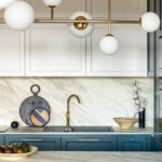 Luxury modern and vintage turquoise and white kitchen. Marble kitchen island with white owal chandelier . Gold tap on marble table top. Template.